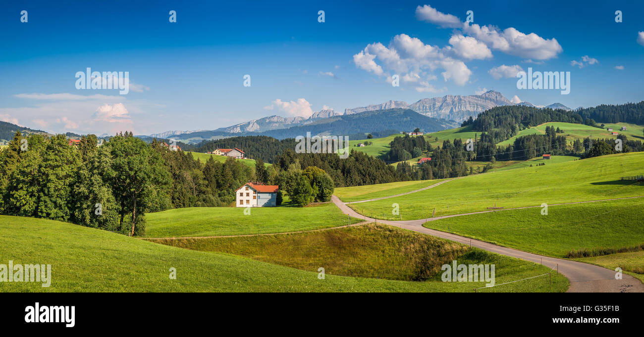 Idyllic landscape in the Alps with green meadows and famous Saentis mountain top in the background, Appenzellerland, Switzerland Stock Photo