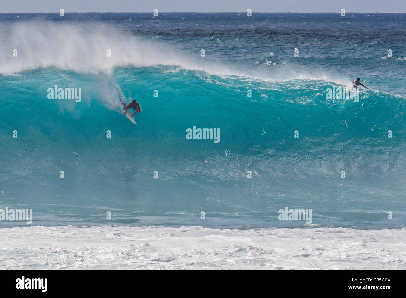 A surfer at Banzai Pipeline during a large swell in the afternoon on the North Shore of Oahu. Stock Photo