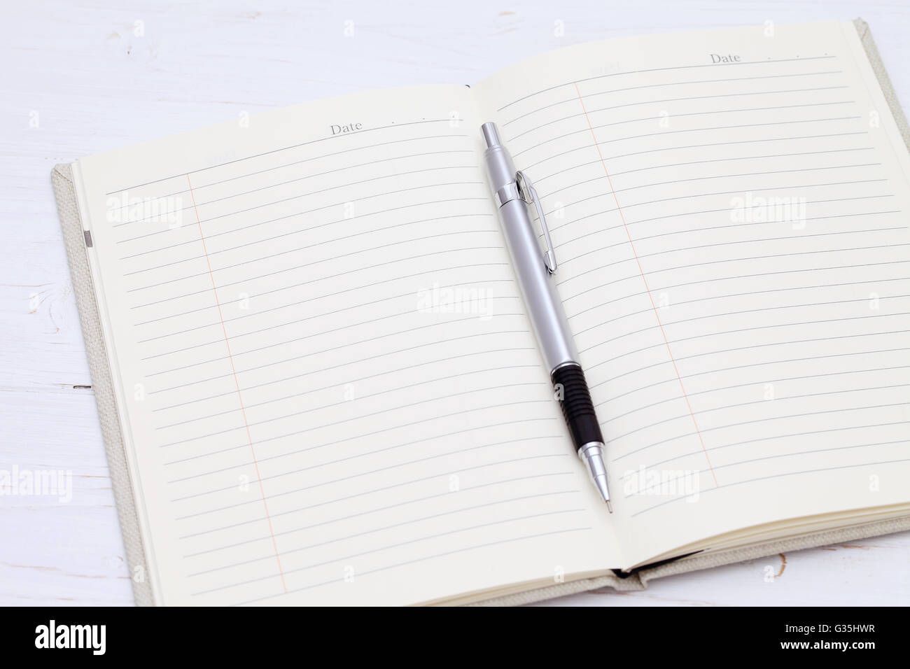 Notebook with pen on the white wooden table Stock Photo