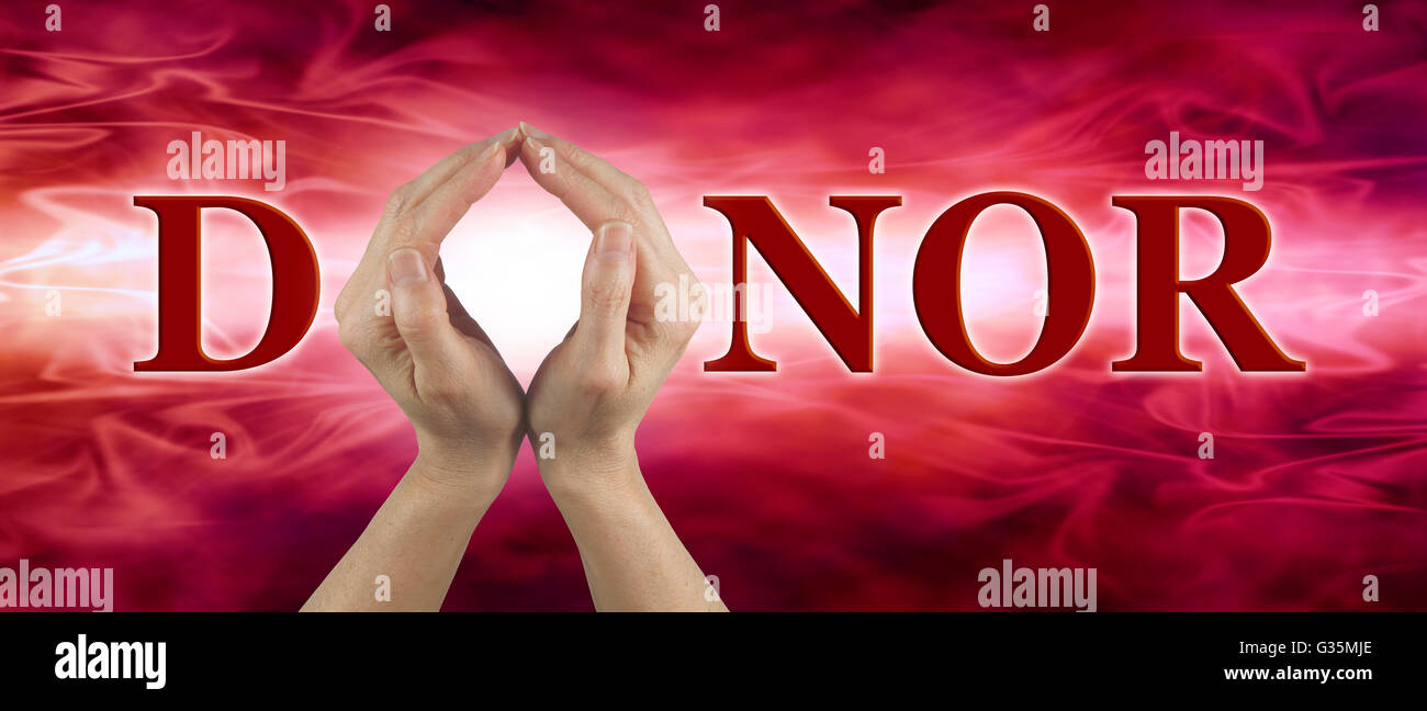 Hands held up to make the shape of an O in the word DONOR, on a red flowing blood-like background with copy space Stock Photo