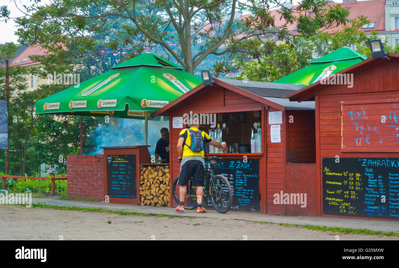 Man with a bicycle, buying a beer, Zahradky Zizkov, beer garden, Zizkov, Prague, Czech Republic, Europe Stock Photo