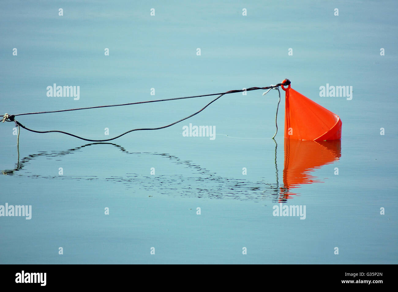 Red buoy on water surface Stock Photo