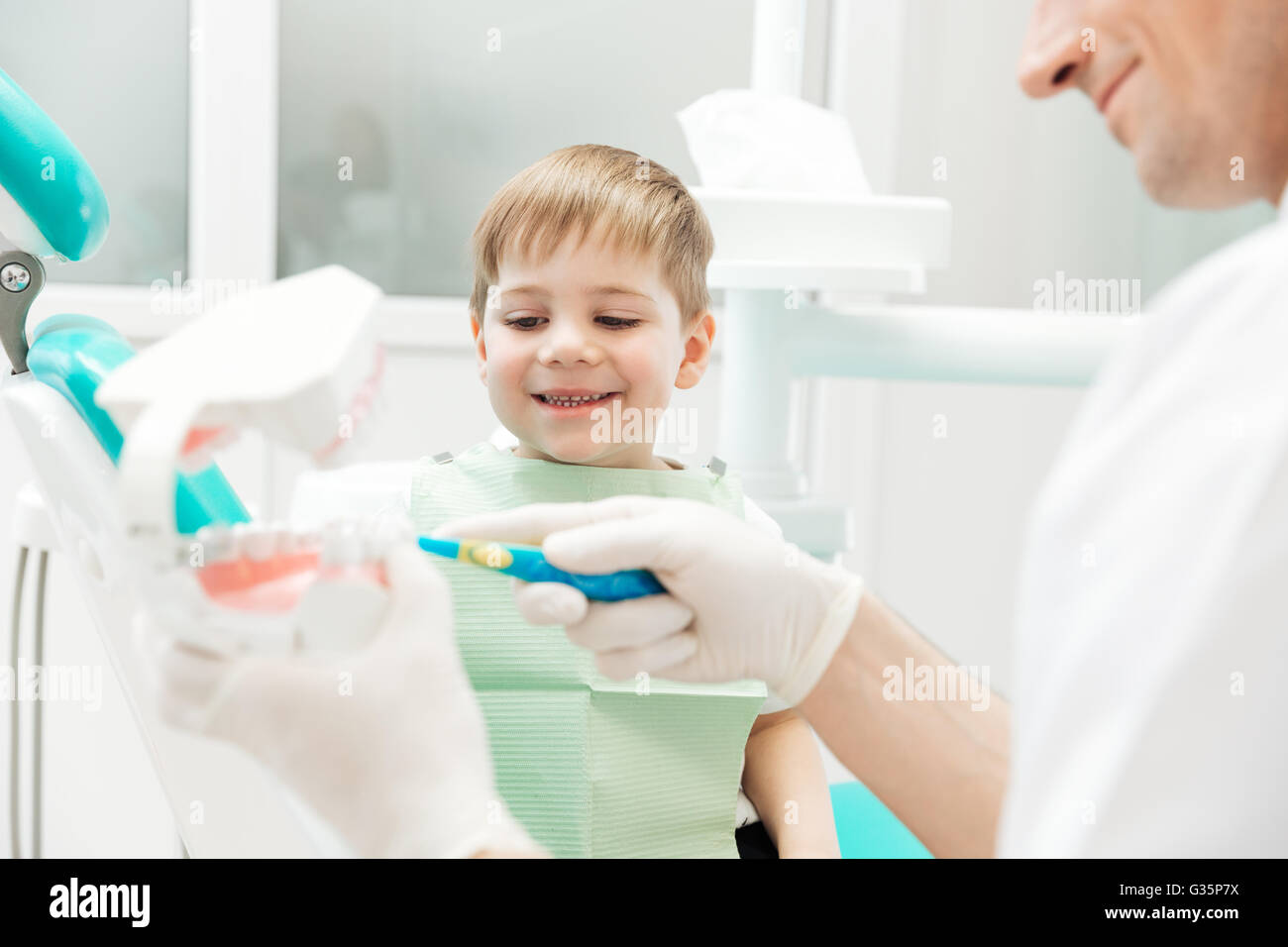 Dentist teaching little boy how to cleaning teeth in dental clinic Stock Photo Alamy