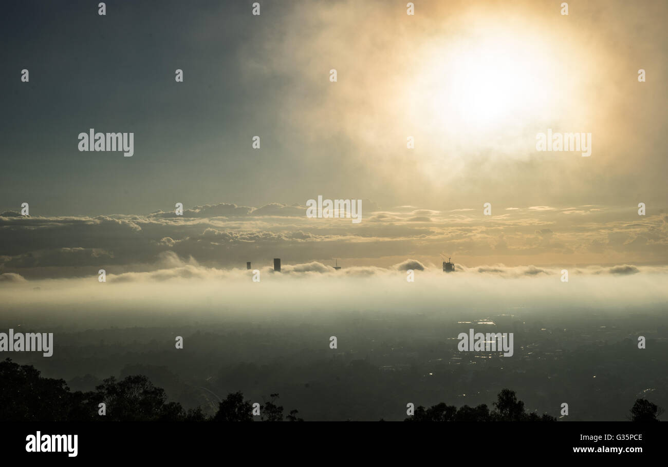 Foggy city scape looking over Brisbane City Australia just after sunrise Stock Photo