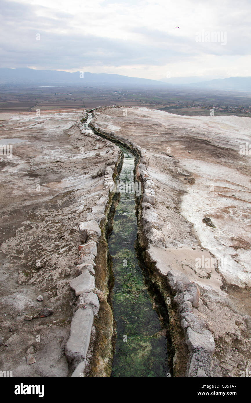 Warm healing water, up to the temperature of a human body at it's source, running down the slope in Pamukkale. Stock Photo