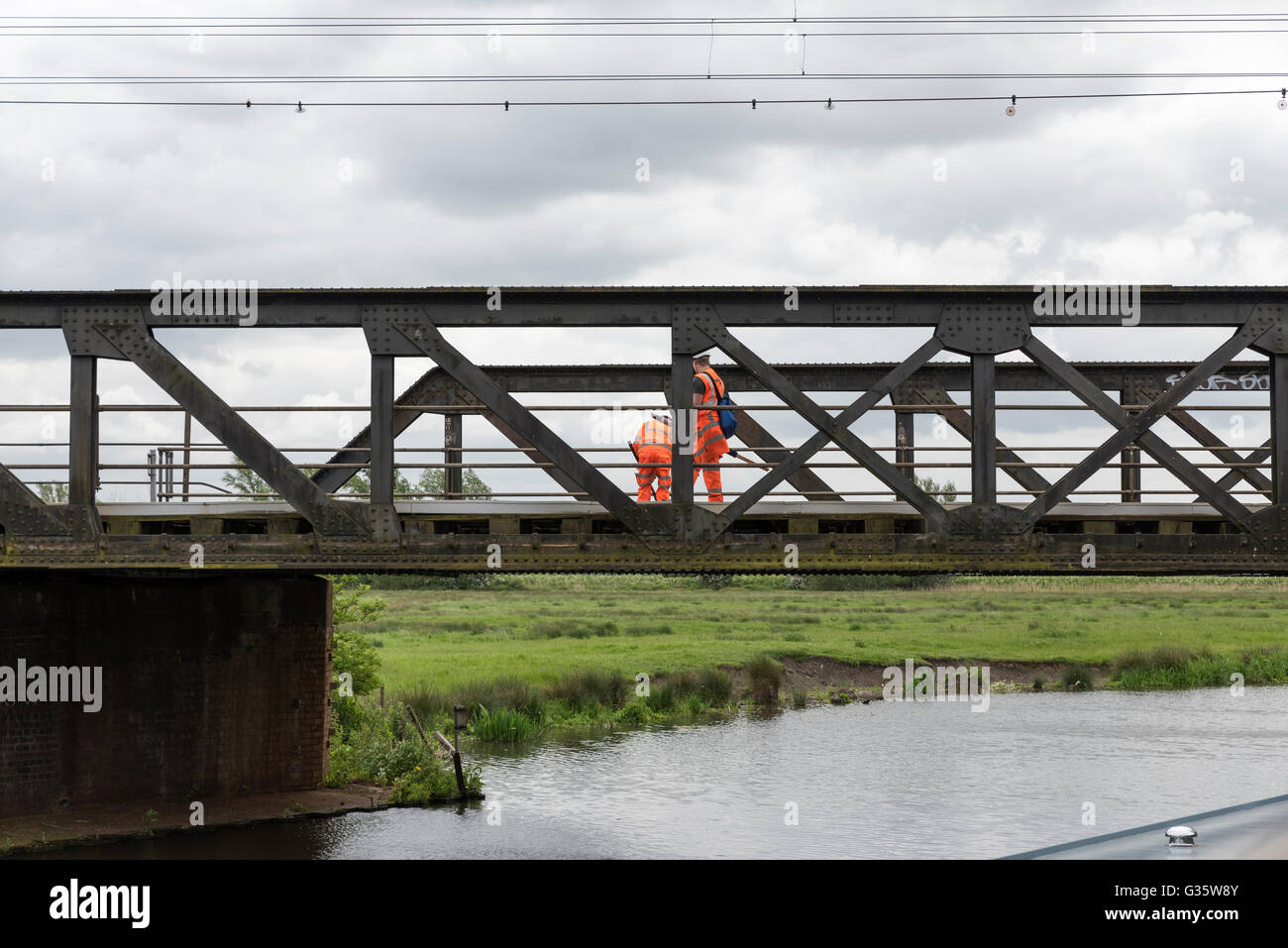 Linesmen checking railway permanent way on truss bridge over river Great Ouse Ely Cambridgeshire England UK Stock Photo
