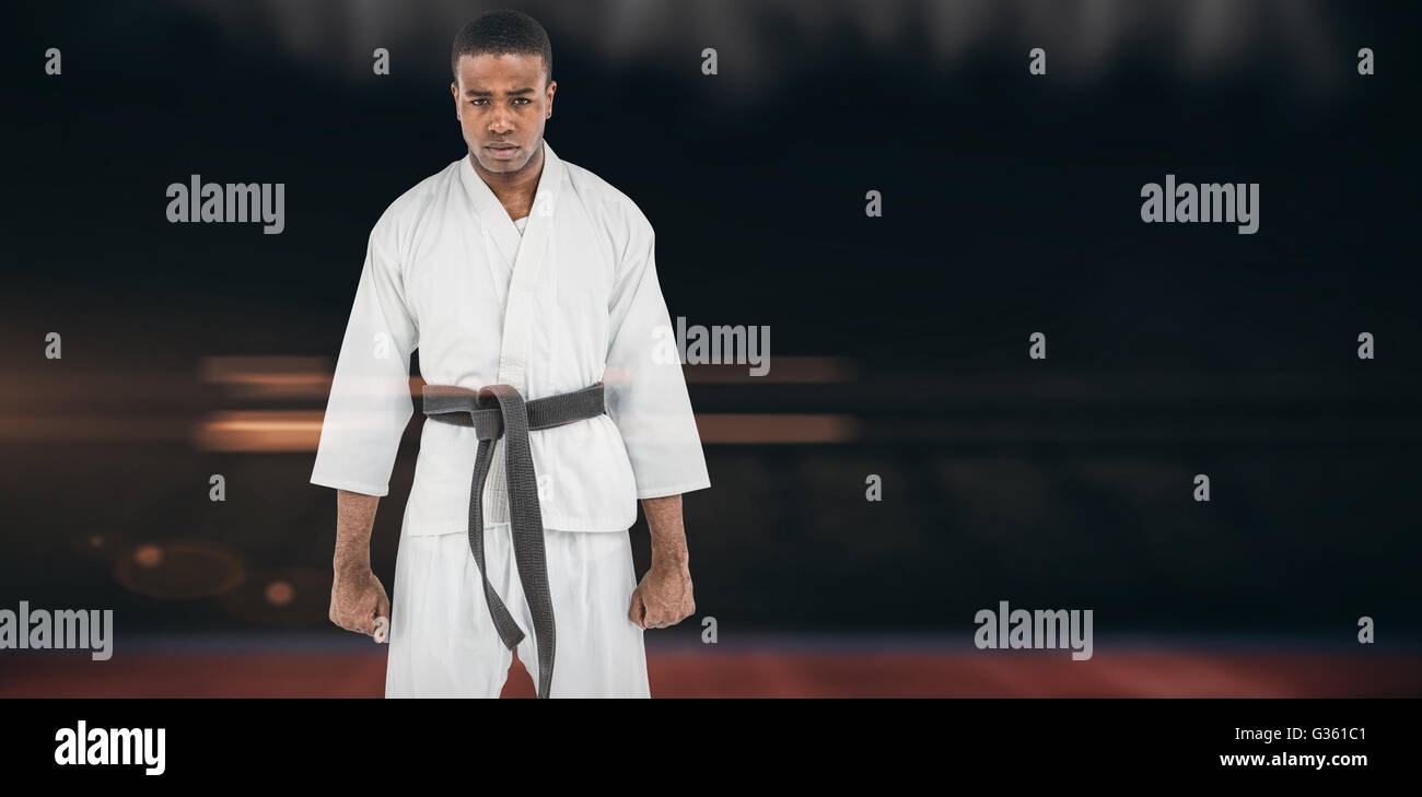 Composite image of portrait of serious karate player Stock Photo