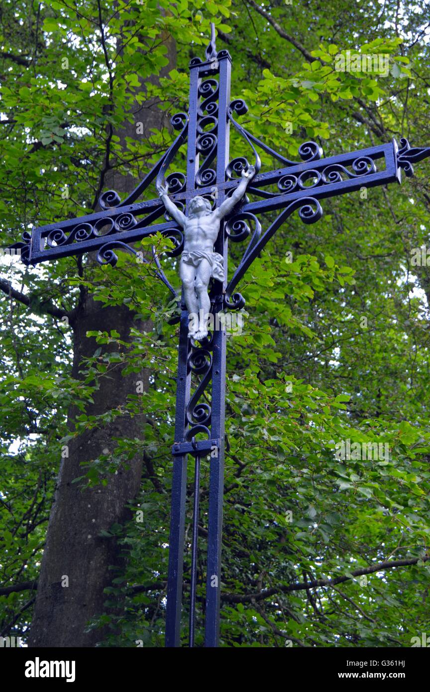 Iron cross to with the Christ in the forest Stock Photo Alamy