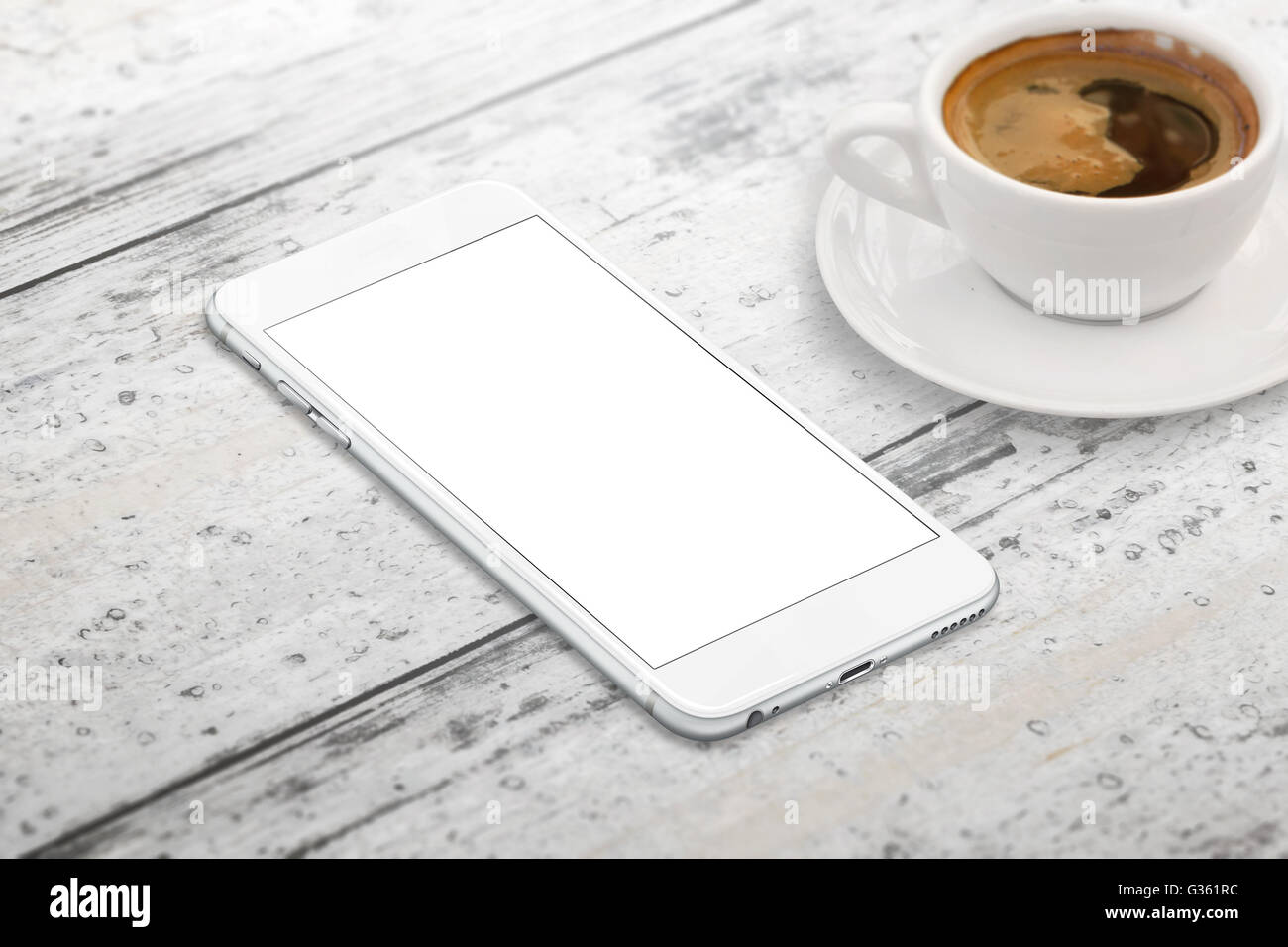 Smart phone with blank screen for mockup. Cup of coffee beside on table. Isometric view. Stock Photo