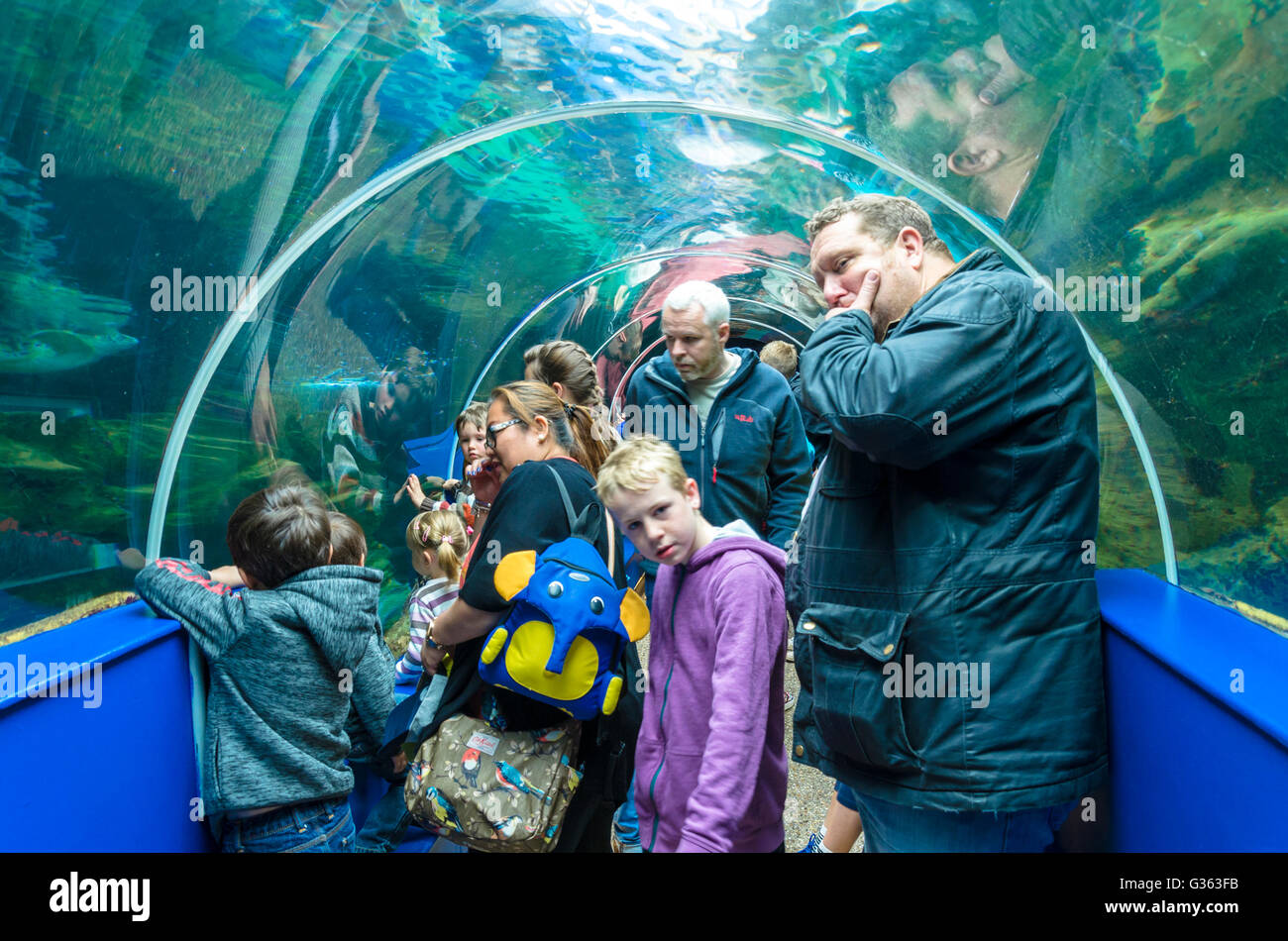 Tourists pass through the tunnel which goes through the Key West