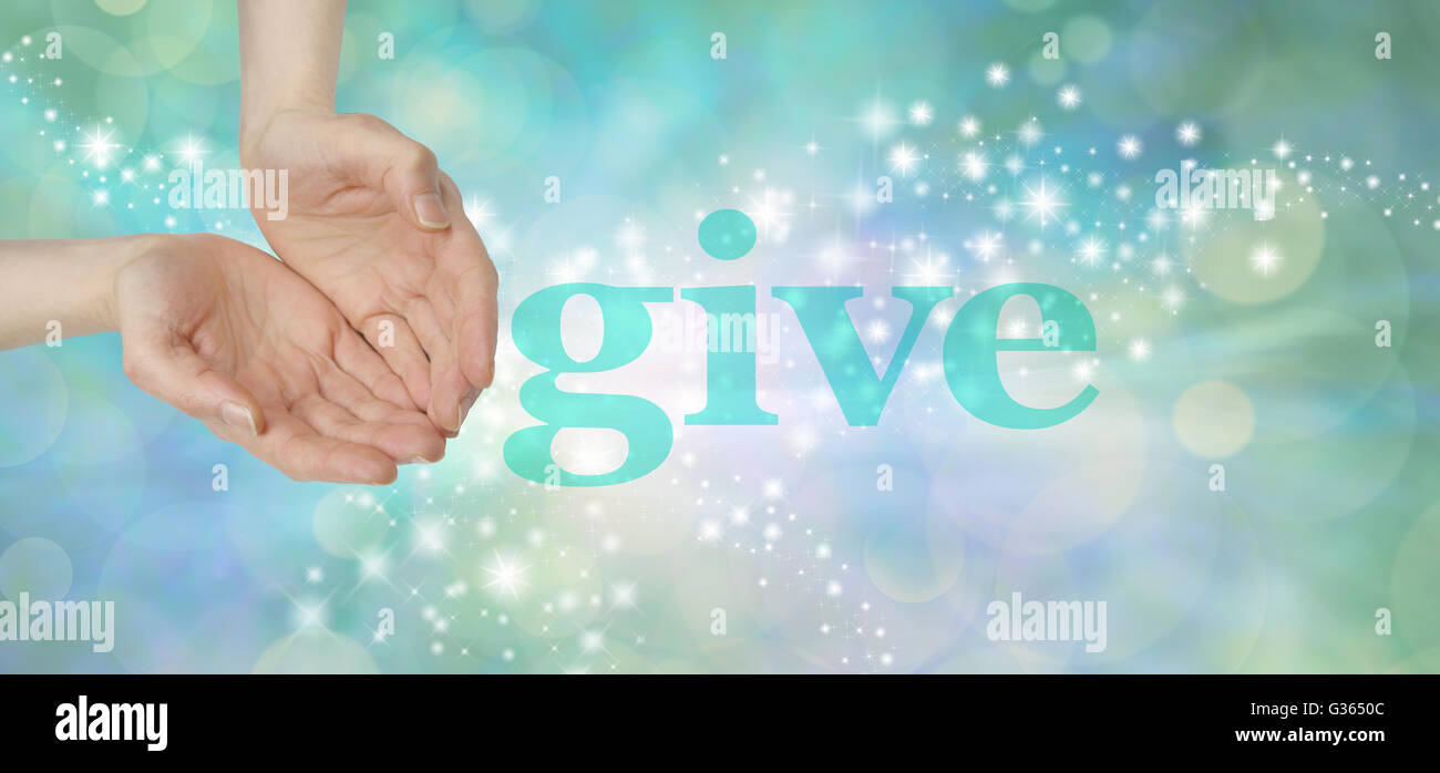 female cupped hands next to the word GIVE on a soft green bokeh background with glittering sparkles moving across Stock Photo