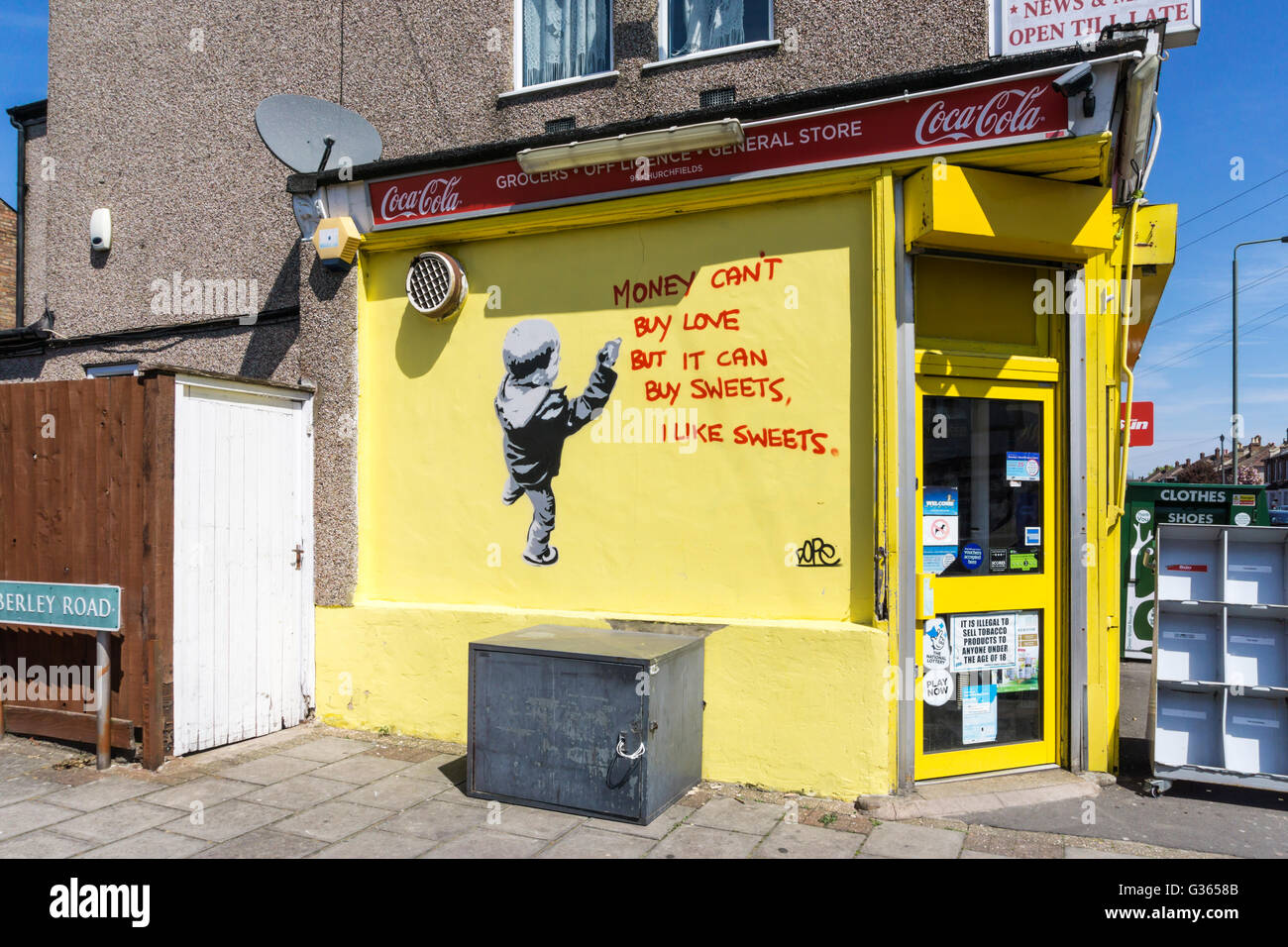'Money can't buy love but it can buy sweets, I like sweets' graffiti by Dope on a sweet-shop in Beckenham, South London. Stock Photo
