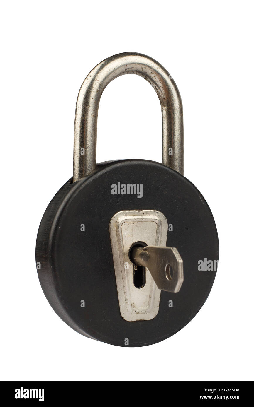 Side view of a vintage black padlock with round shape isolated on white background being open by a key Stock Photo
