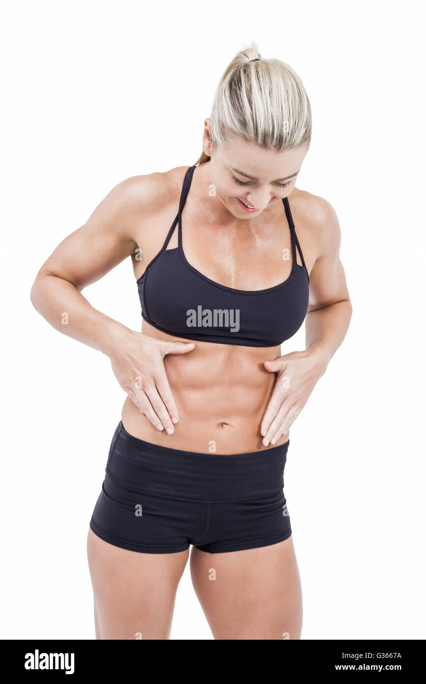 Female athlete touching her abs Stock Photo