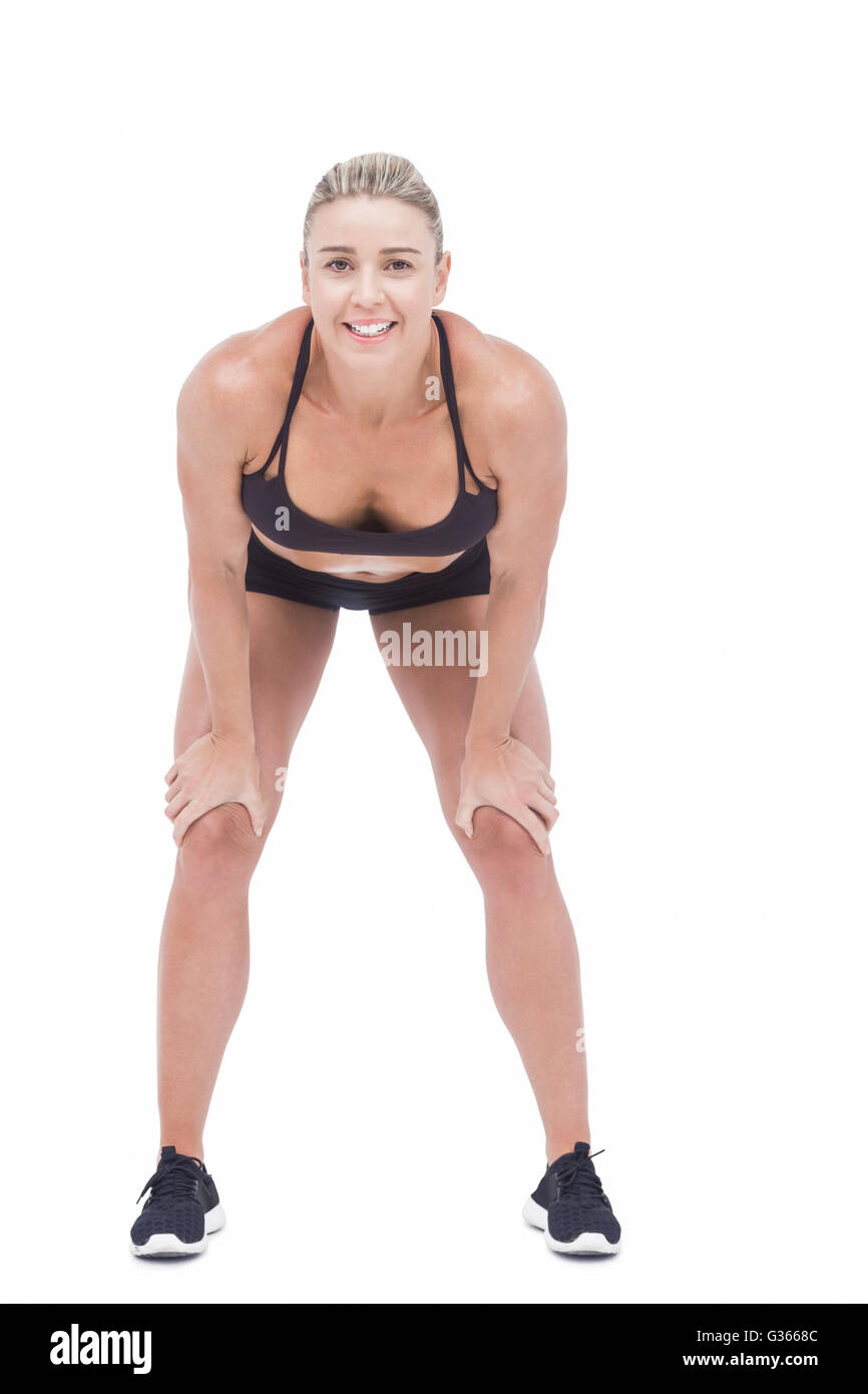 Female athlete with hands on knees Stock Photo