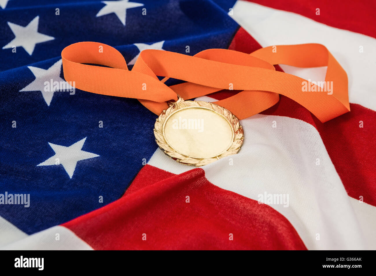 Close-up of gold medal on american flag Stock Photo