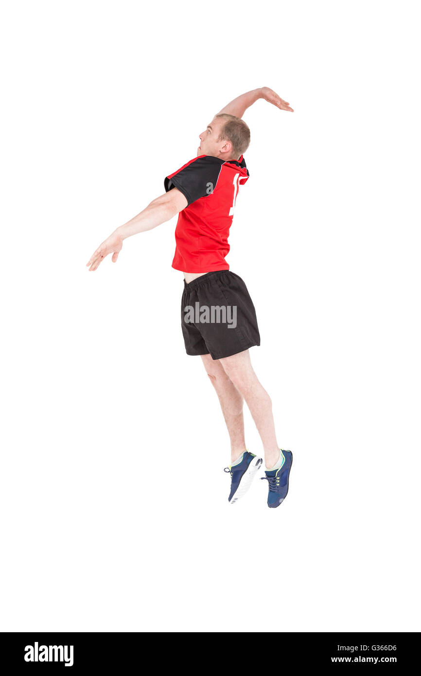 Sportsman hitting volleyball Stock Photo