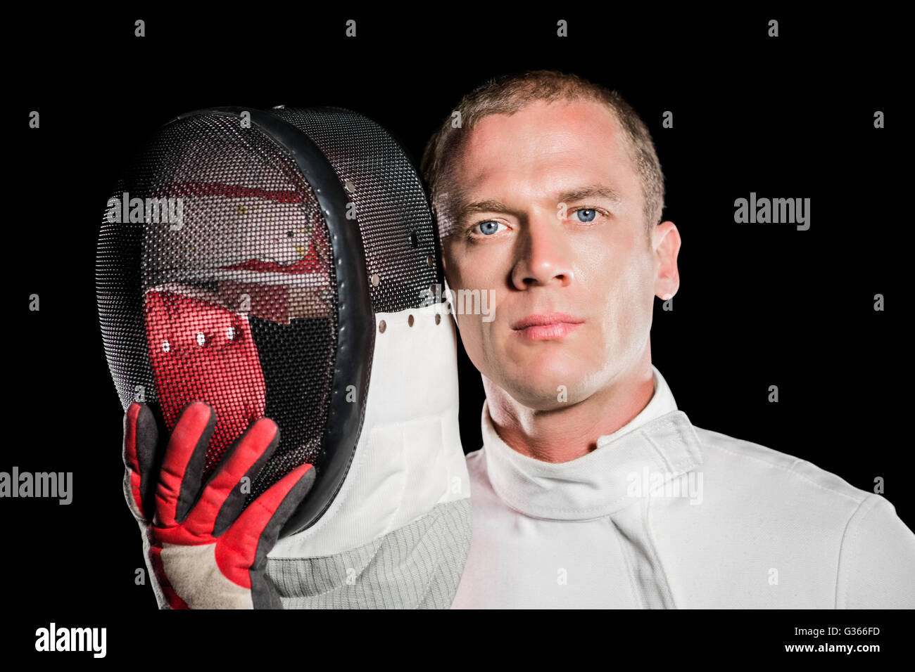 Close-up of swordsman holding fencing mask Stock Photo