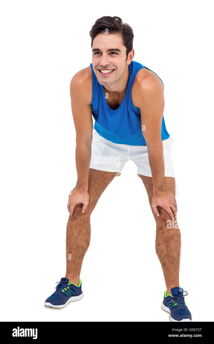 Male athlete standing with hand on knee Stock Photo Alamy