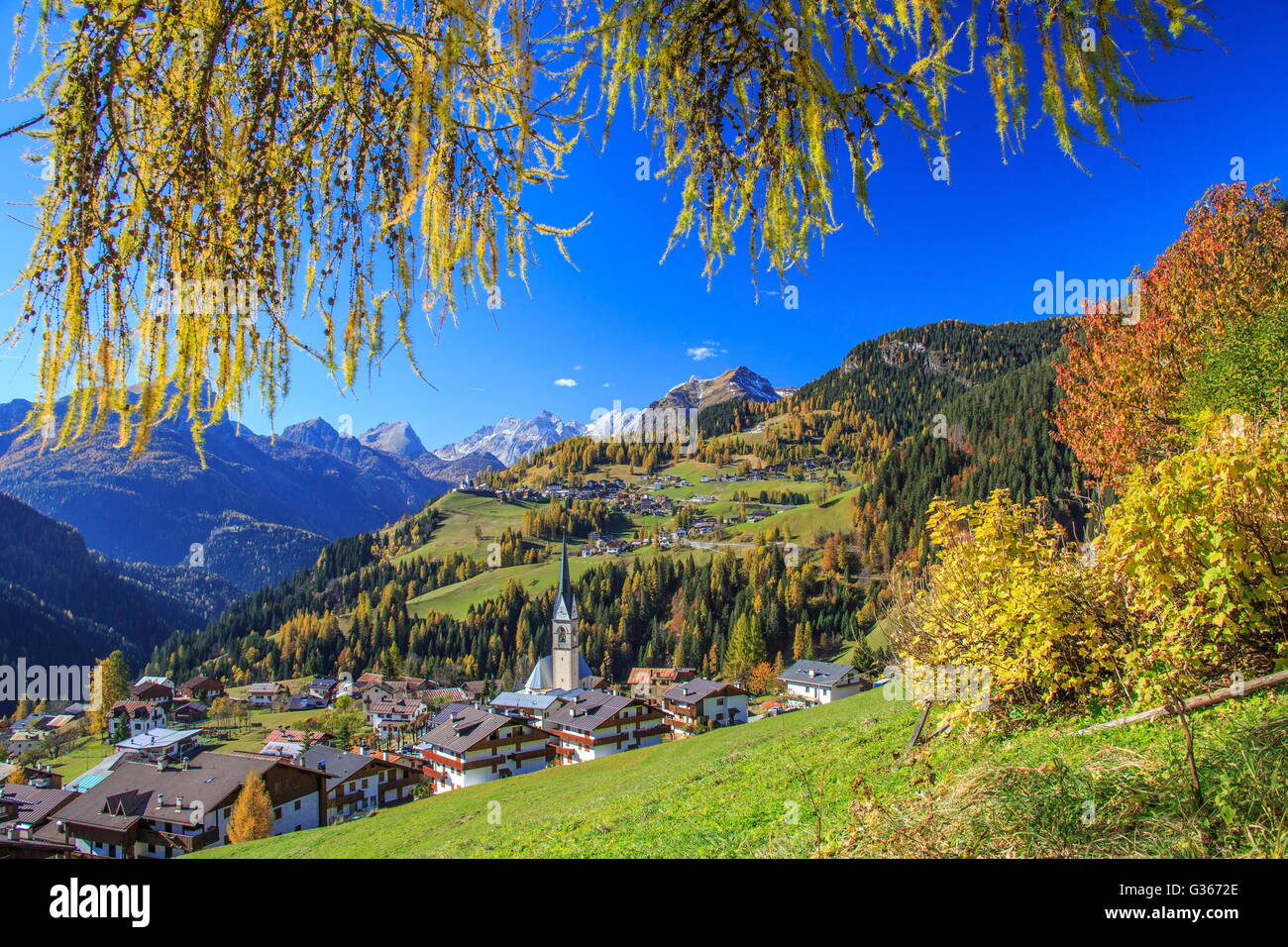Autumn colors frames the alpine village surrounded by woods Selva of Cadore Val Fiorentina Belluno Dolomites Veneto Italy Europe Stock Photo
