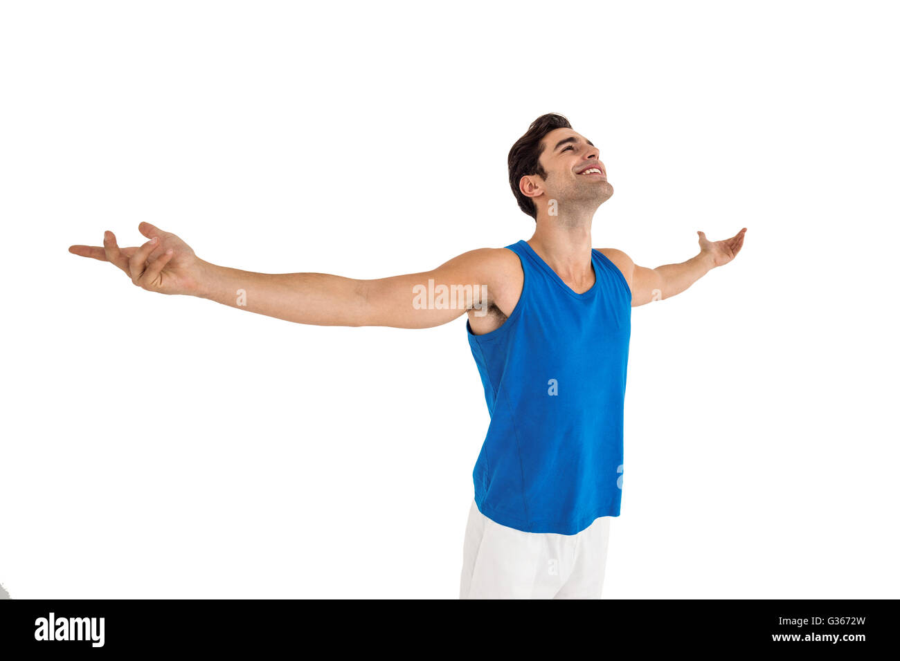 Excited male athlete with arms outstretched Stock Photo