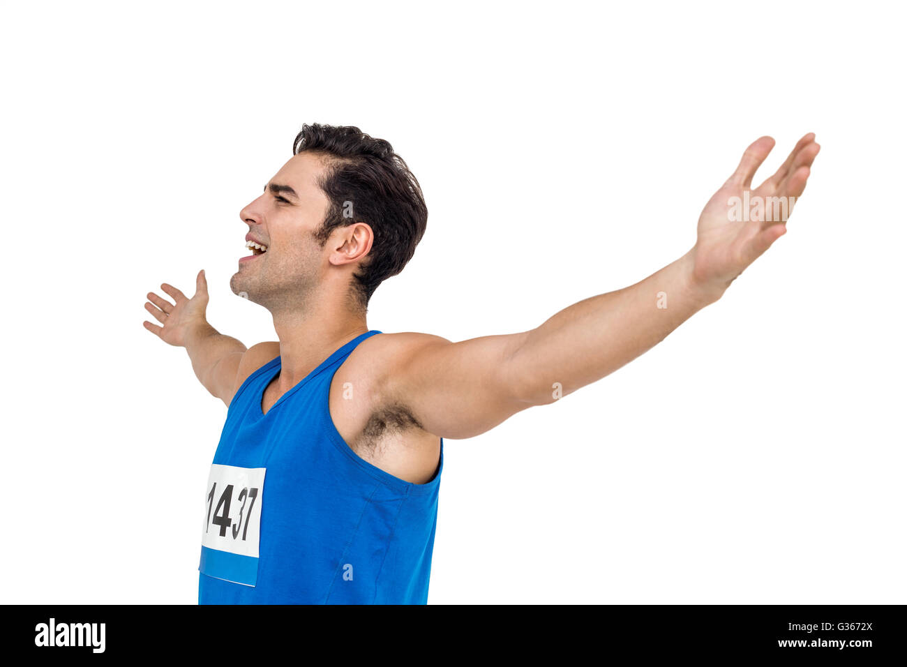 Excited male athlete with arms outstretched Stock Photo