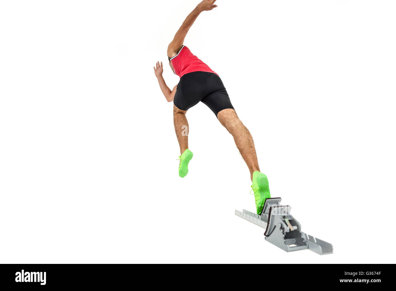 Male athlete running from starting blocks Stock Photo