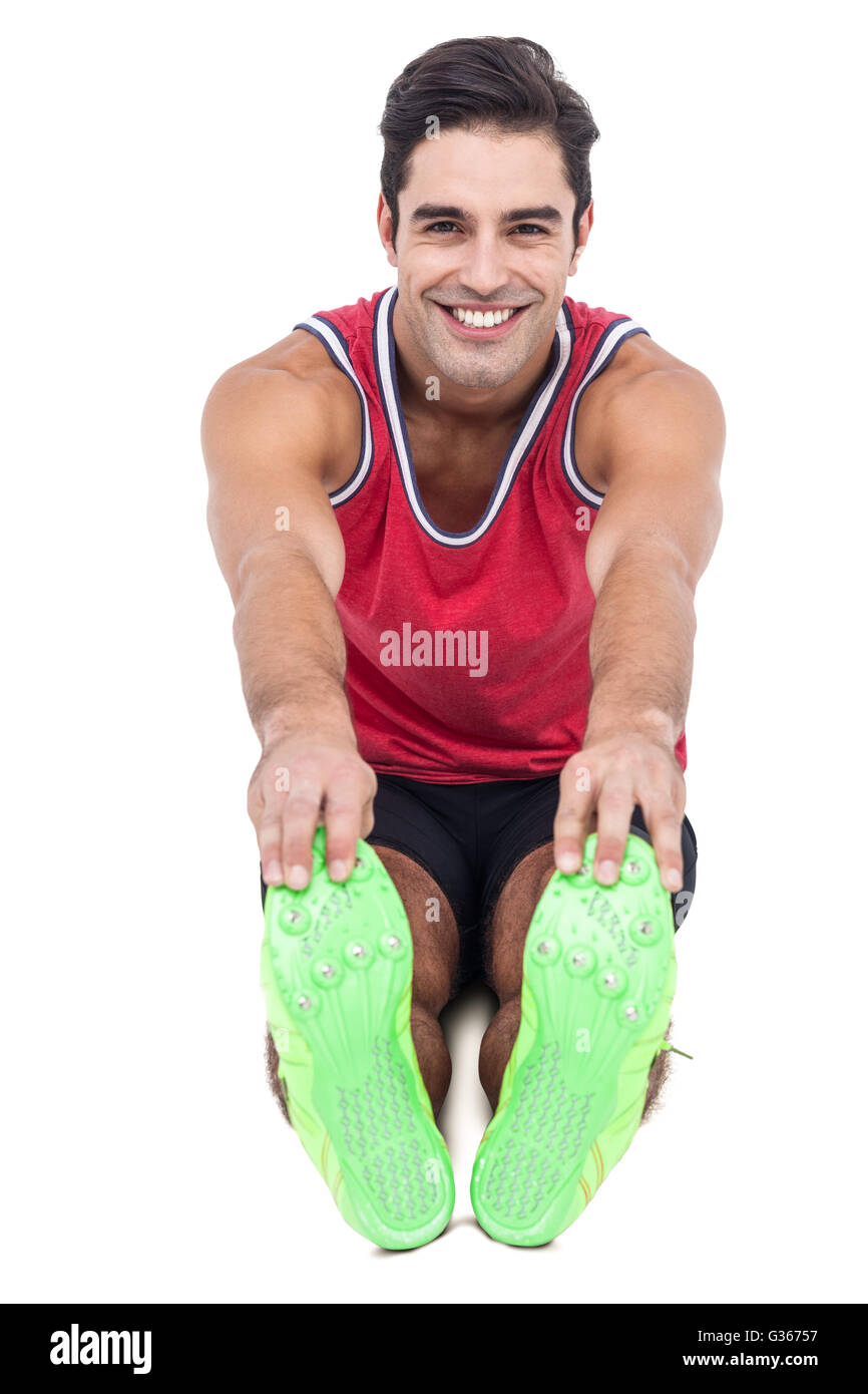 Portrait of male athlete doing stretching exercise Stock Photo