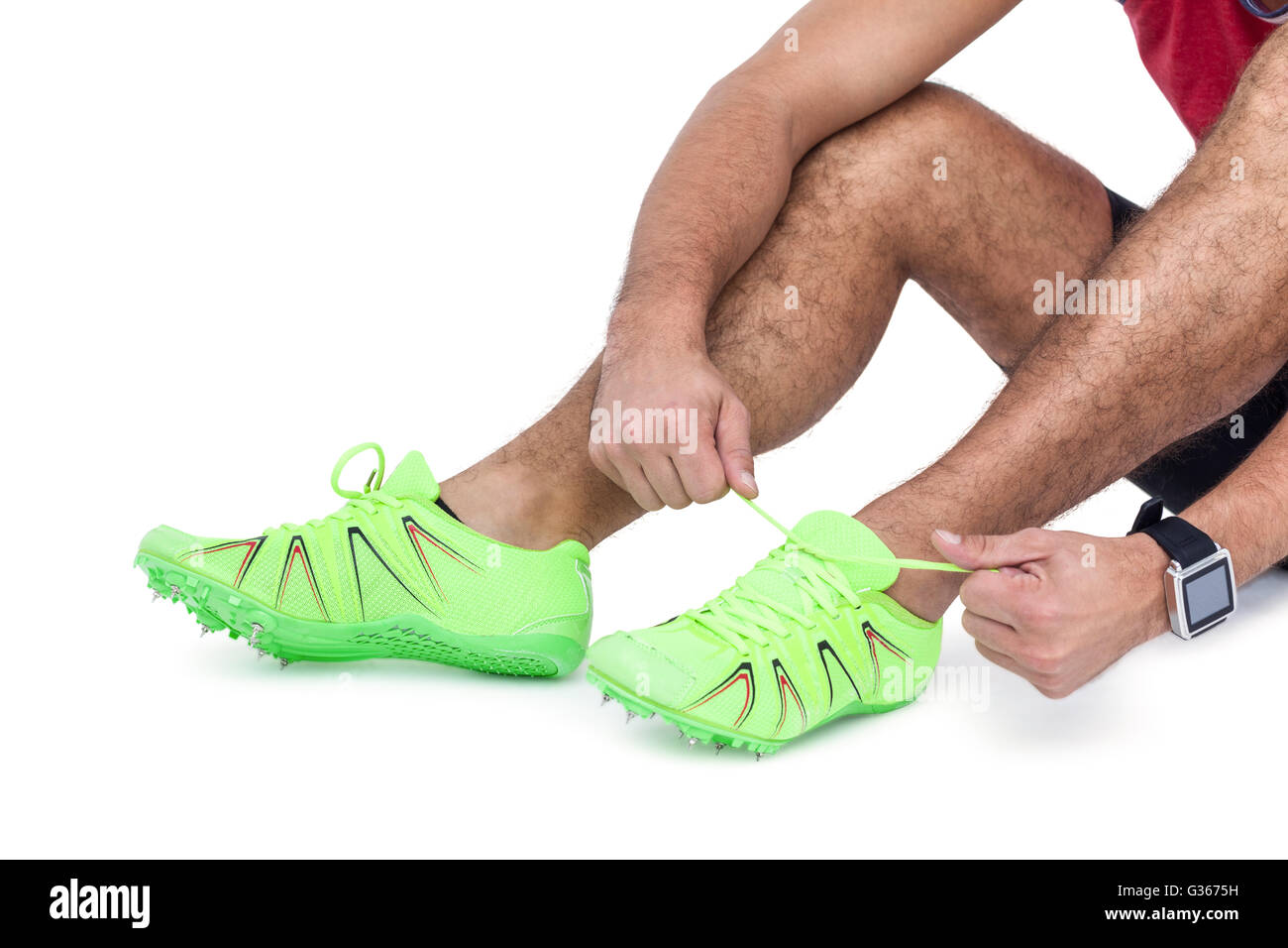 Male athlete tying his running shoes Stock Photo
