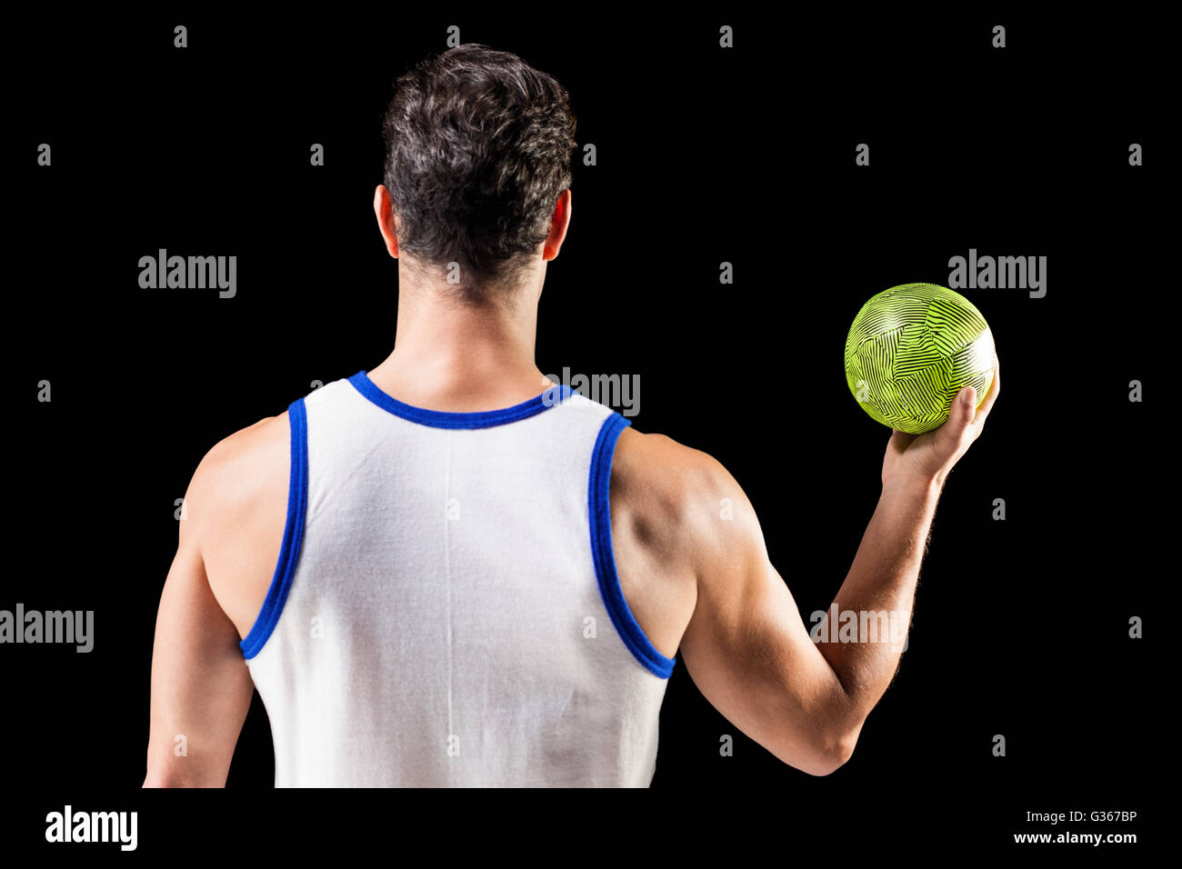 Rear view of male athlete holding ball Stock Photo