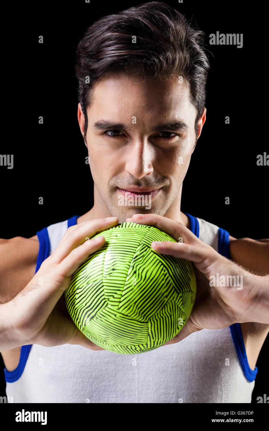 Portrait of happy athlete man holding ball Stock Photo