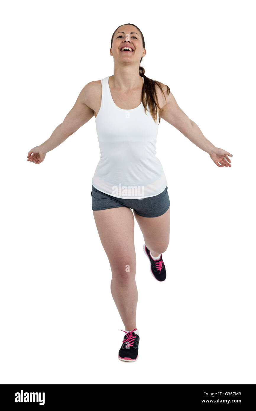 Energetic female athlete running Stock Photo