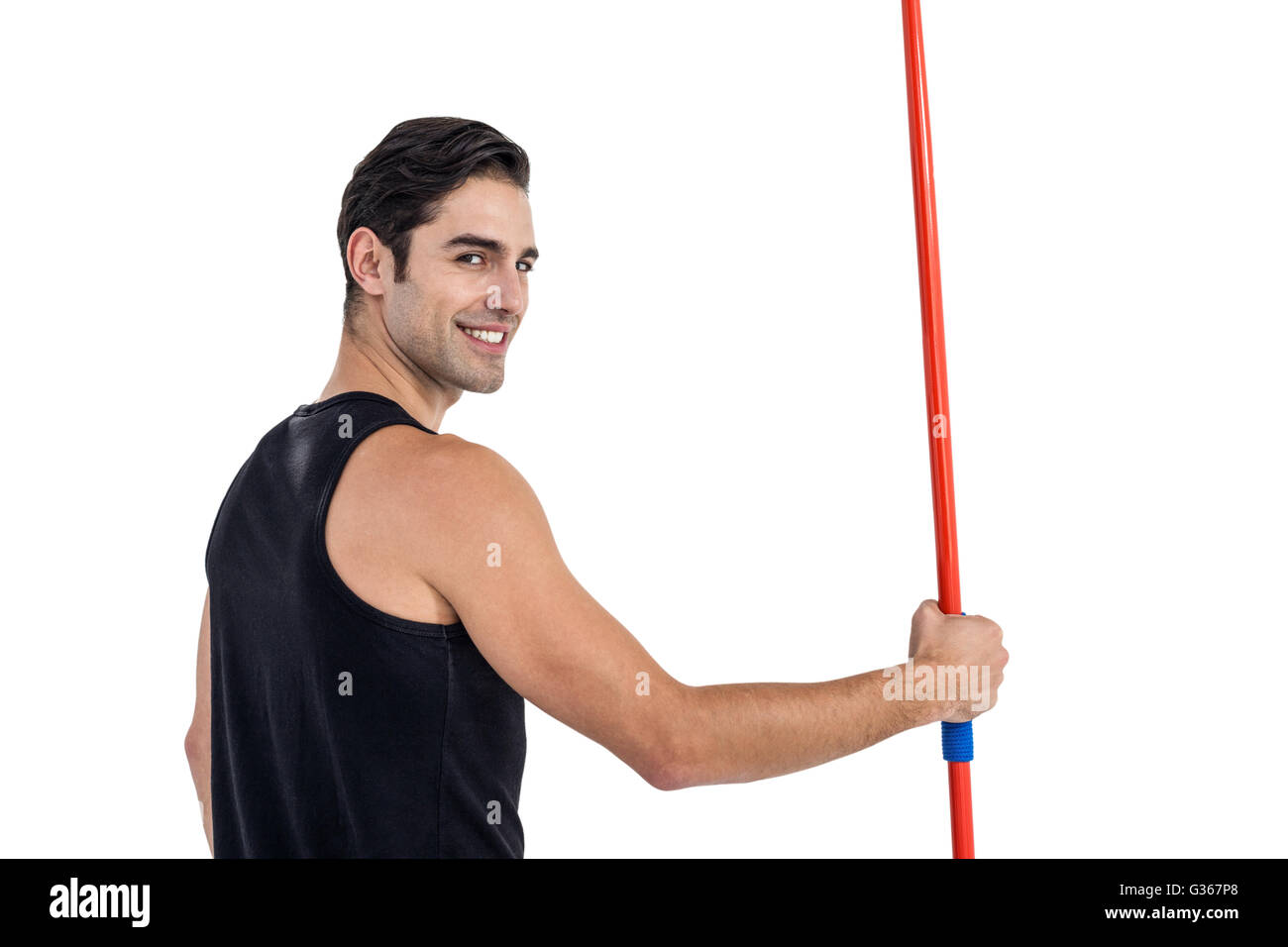 Portrait of happy male athlete holding javelin Stock Photo