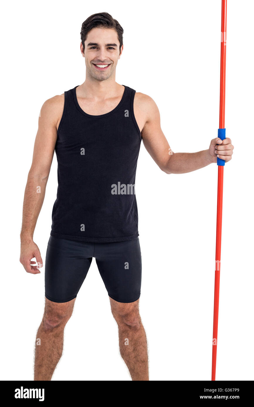 Portrait of happy male athlete holding javelin Stock Photo