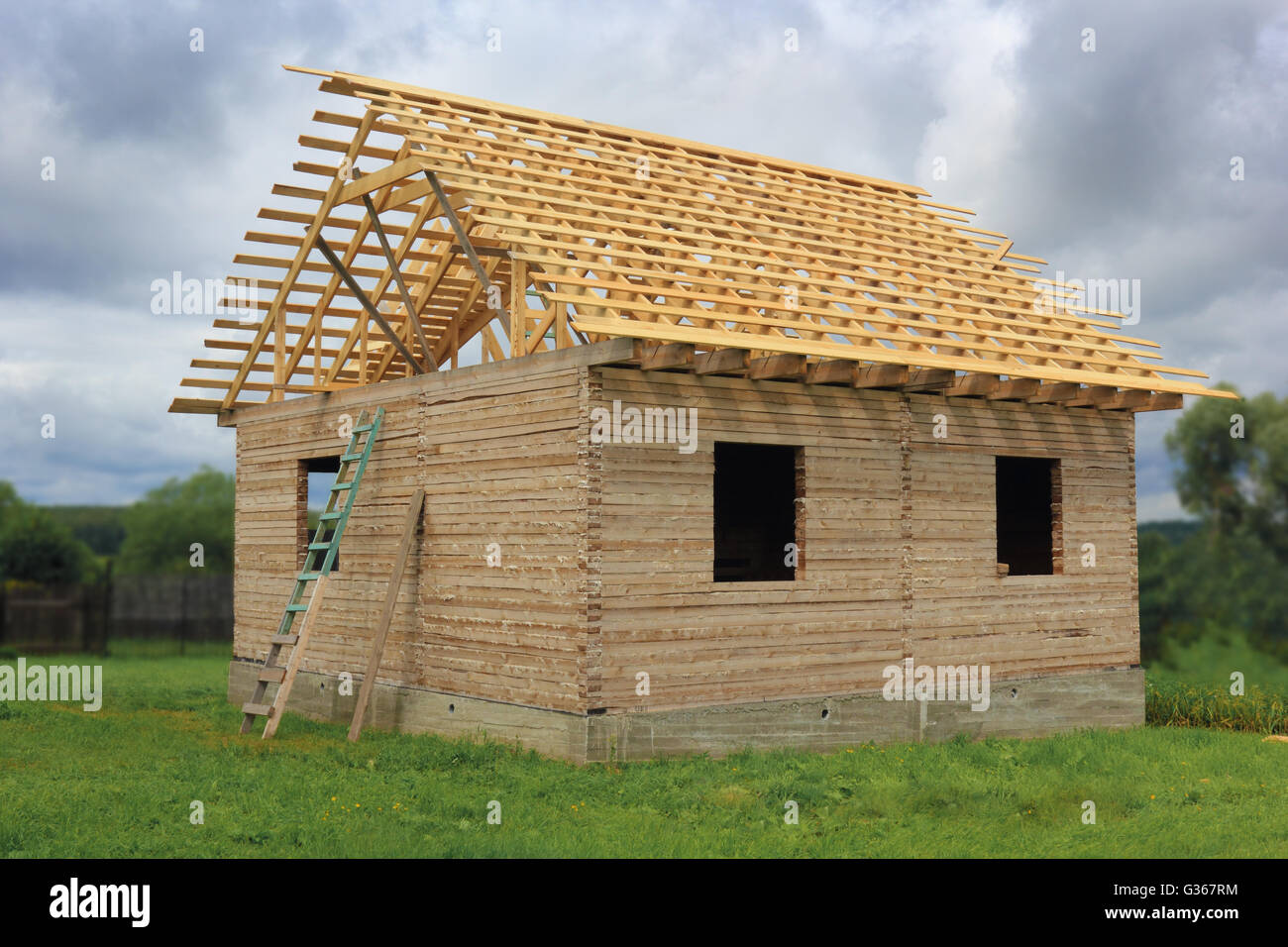 Timber house under construction with roof frame photo Stock Photo Alamy