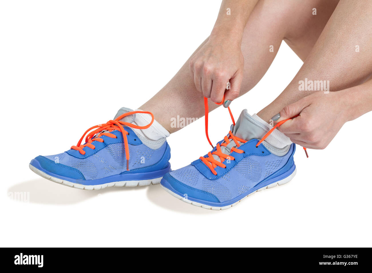 Athlete woman tying her running shoes Stock Photo