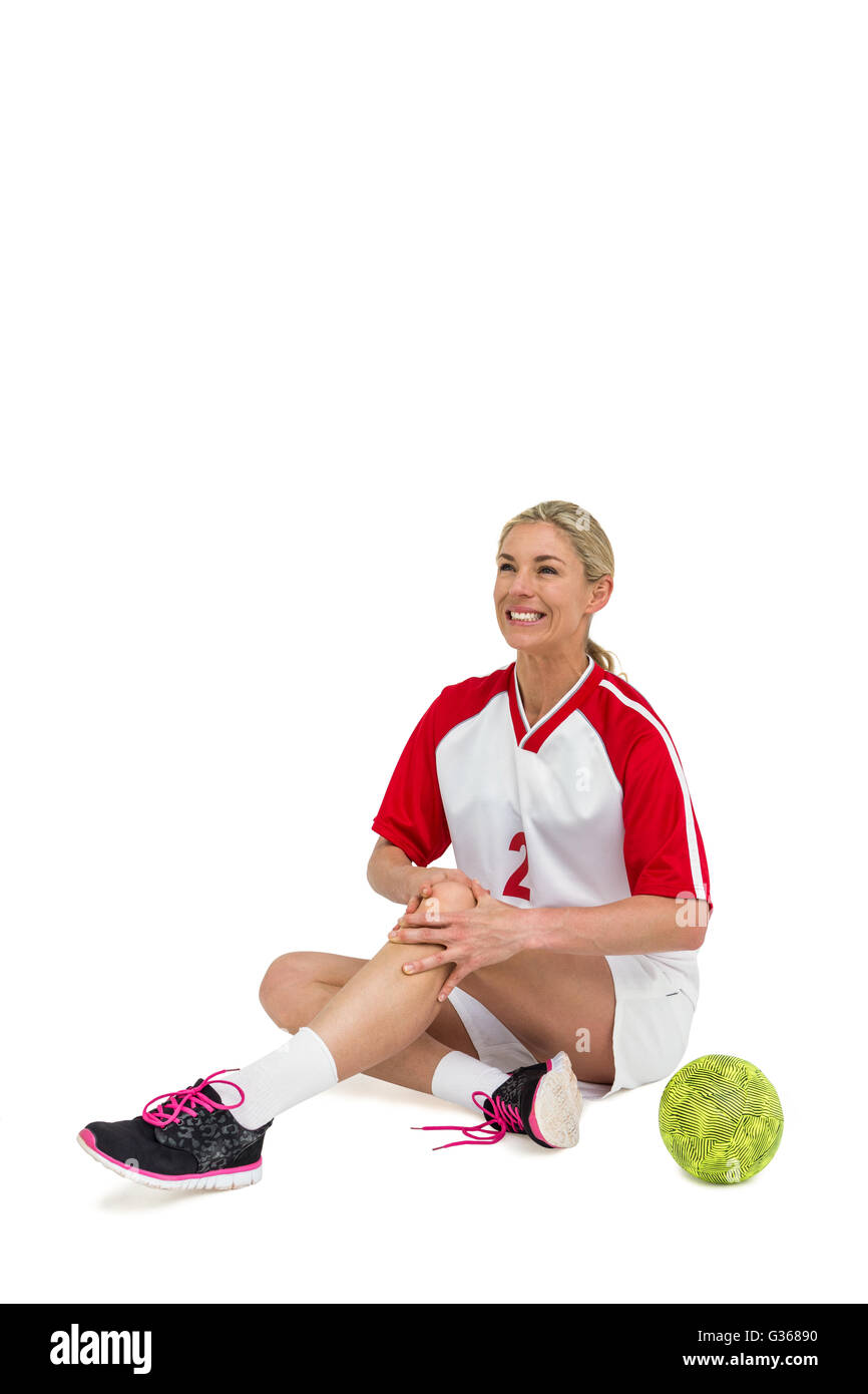 Sportswoman touching her knee Stock Photo