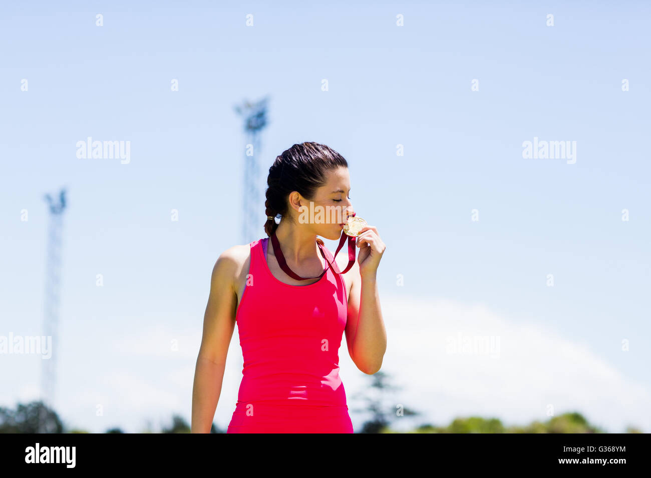 Female athlete kissing her gold medals Stock Photo Alamy
