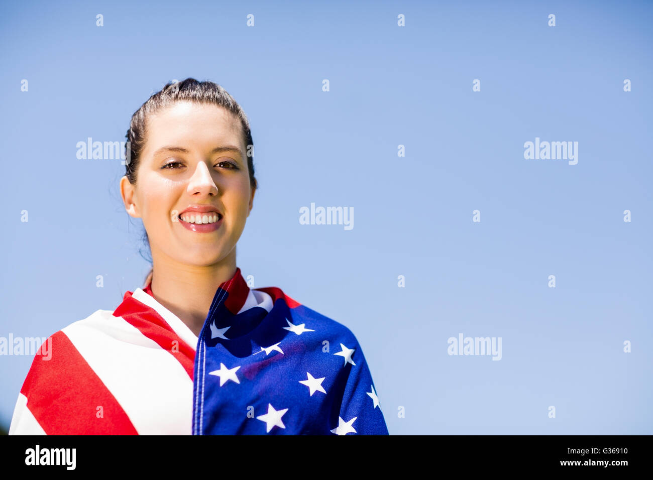 Female athlete wrapped in american flag Stock Photo - Alamy
