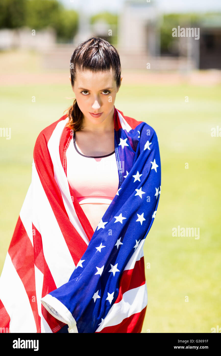 Female athlete wrapped in american flag Stock Photo - Alamy