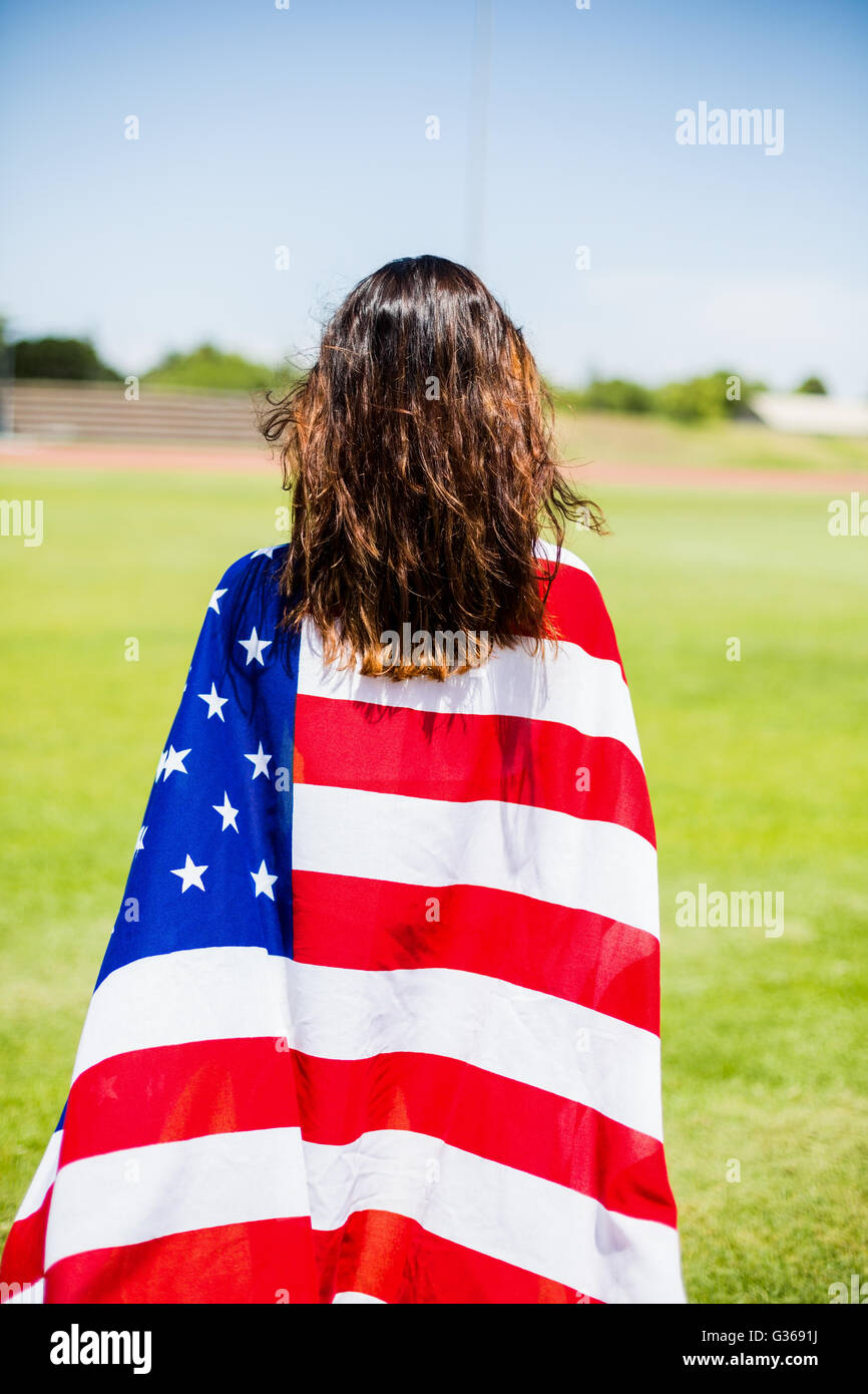 Female athlete wrapped in american flag Stock Photo - Alamy