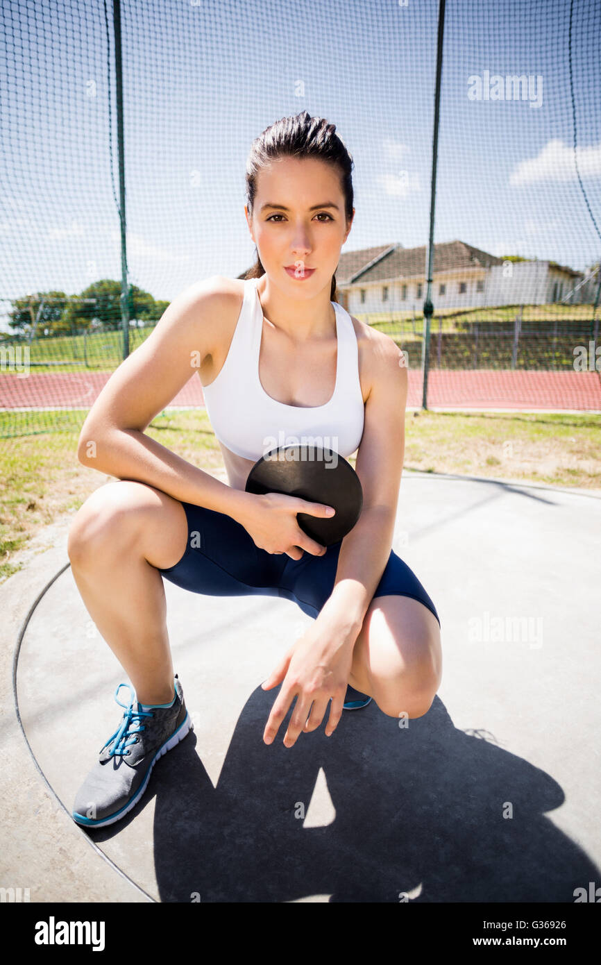 Portrait of confident female athlete holding a discus Stock Photo