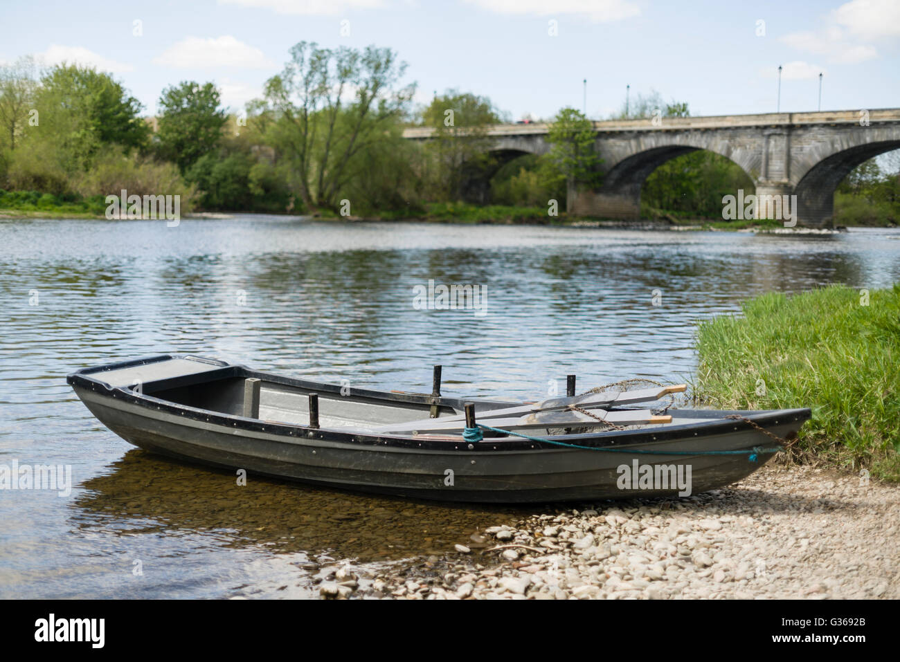 Rennie's Bridge and fishing boat, River Tweed, Kelso, Scotland. Bridge in softer focus boat very