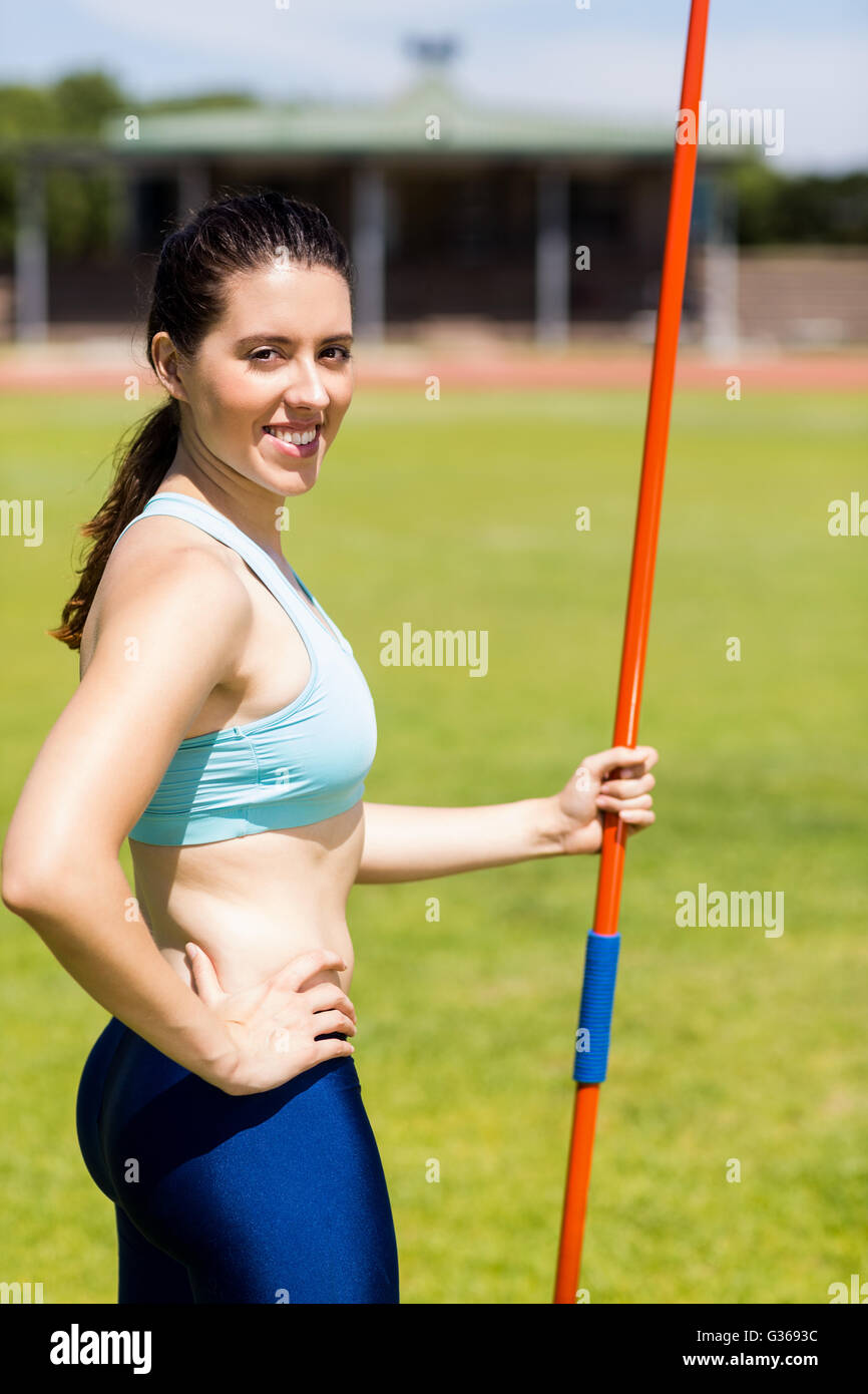 Portrait of female athlete standing with javelin Stock Photo Alamy