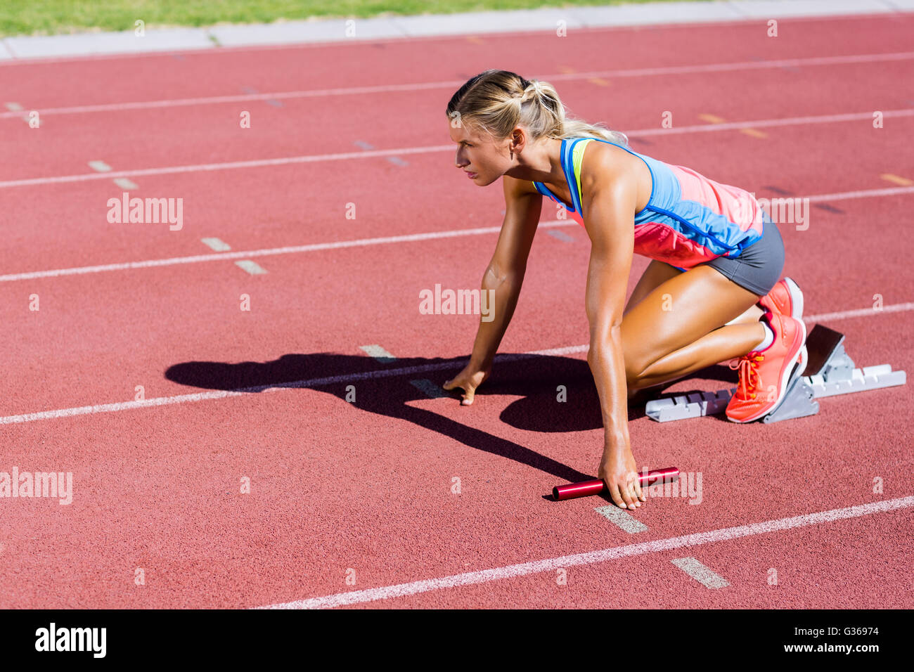 Female athlete ready to start the relay race Stock Photo Alamy