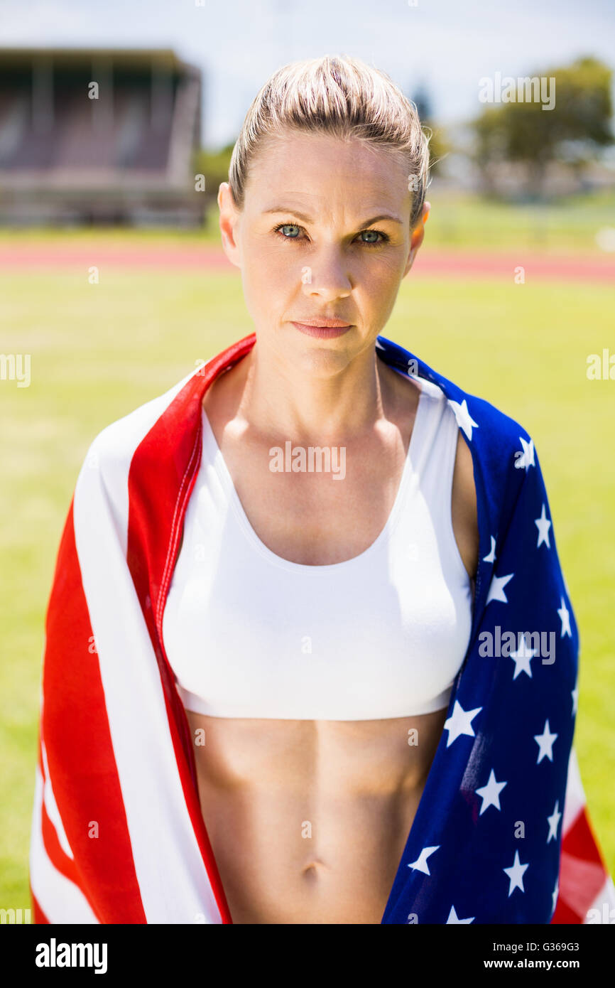Portrait of female athlete wrapped in american flag Stock Photo - Alamy