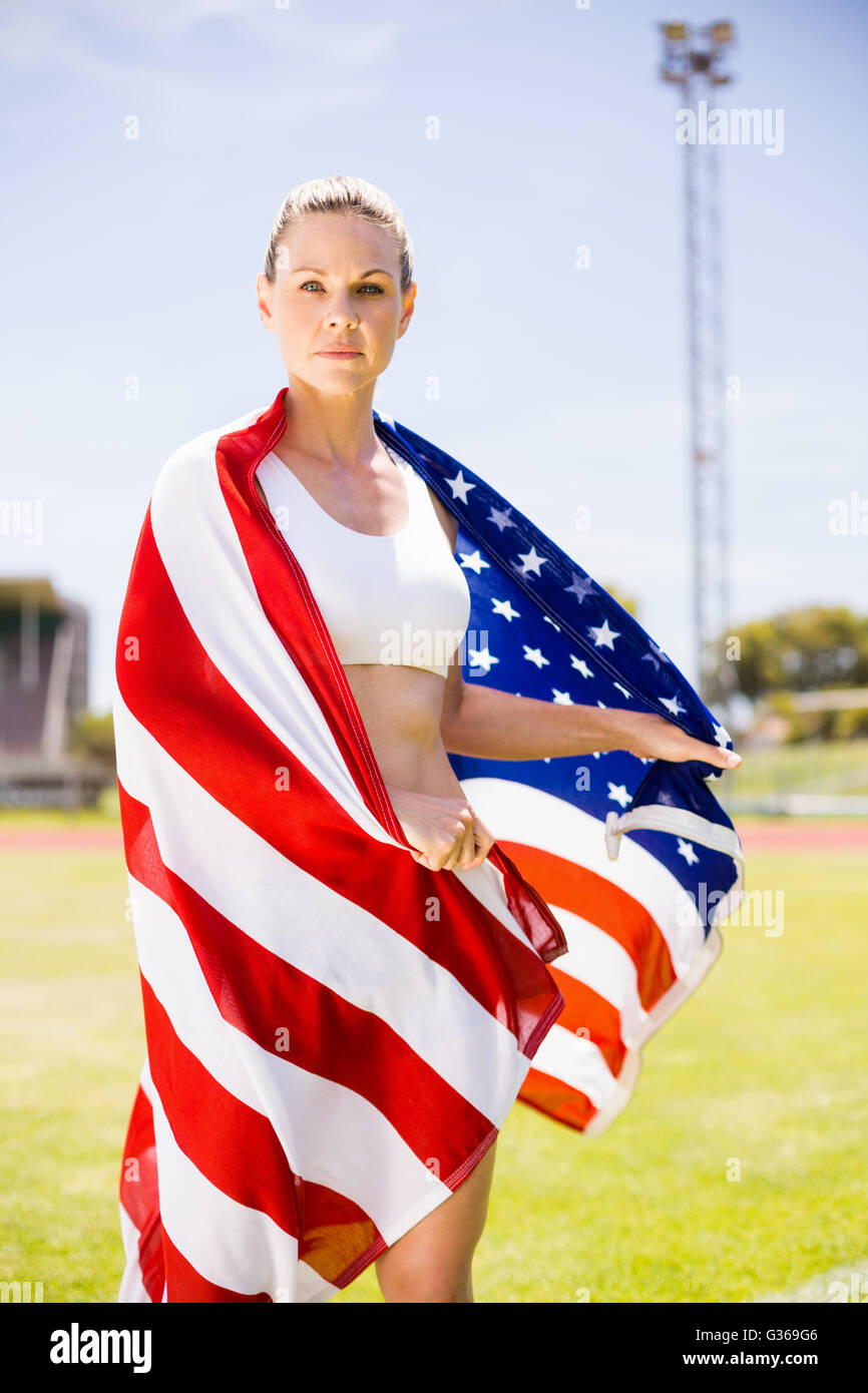 Portrait of female athlete wrapped in american flag Stock Photo - Alamy