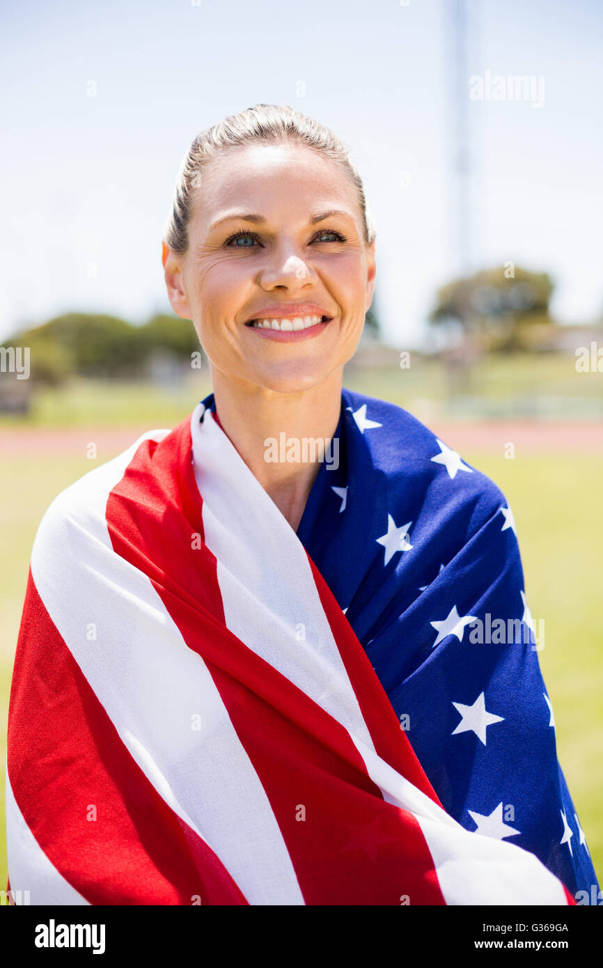Happy female athlete wrapped in american flag Stock Photo - Alamy