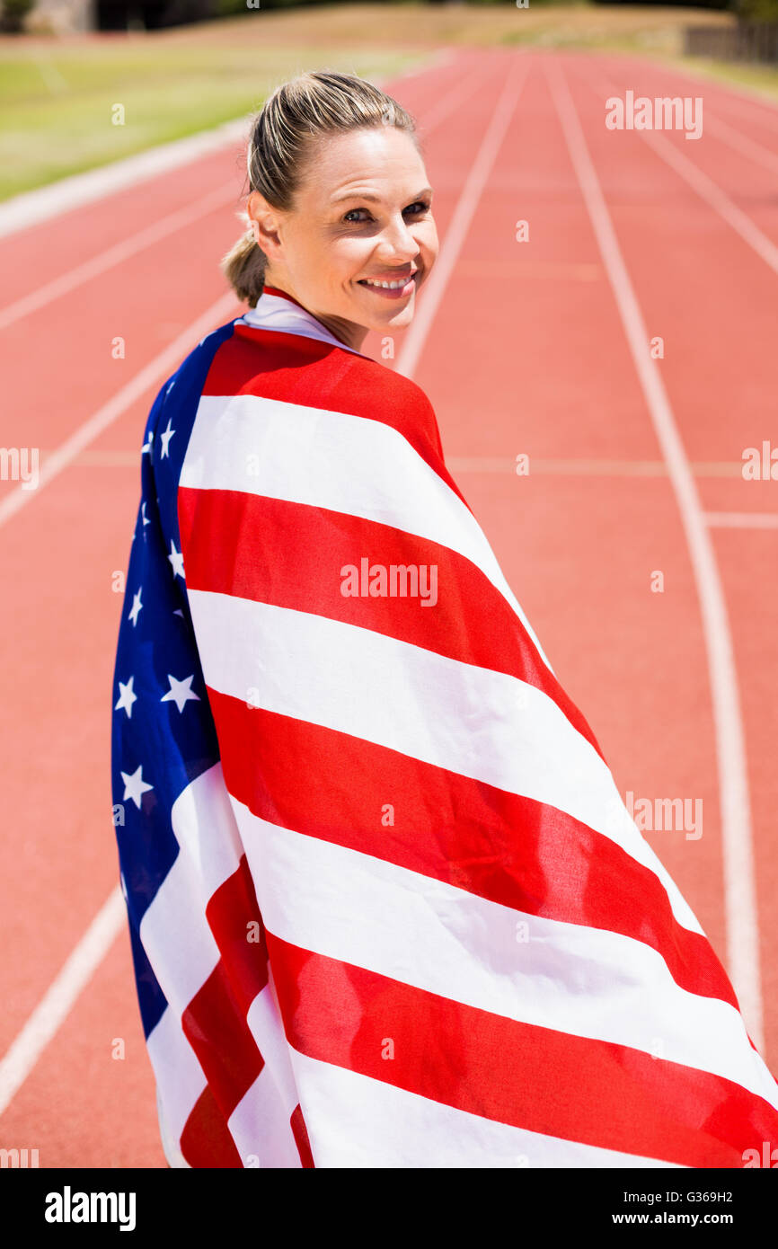 Portrait of female athlete wrapped in american flag Stock Photo - Alamy