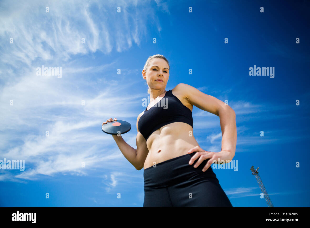 Portrait of female athlete holding a discus Stock Photo